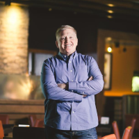 A man standing in front of some tables